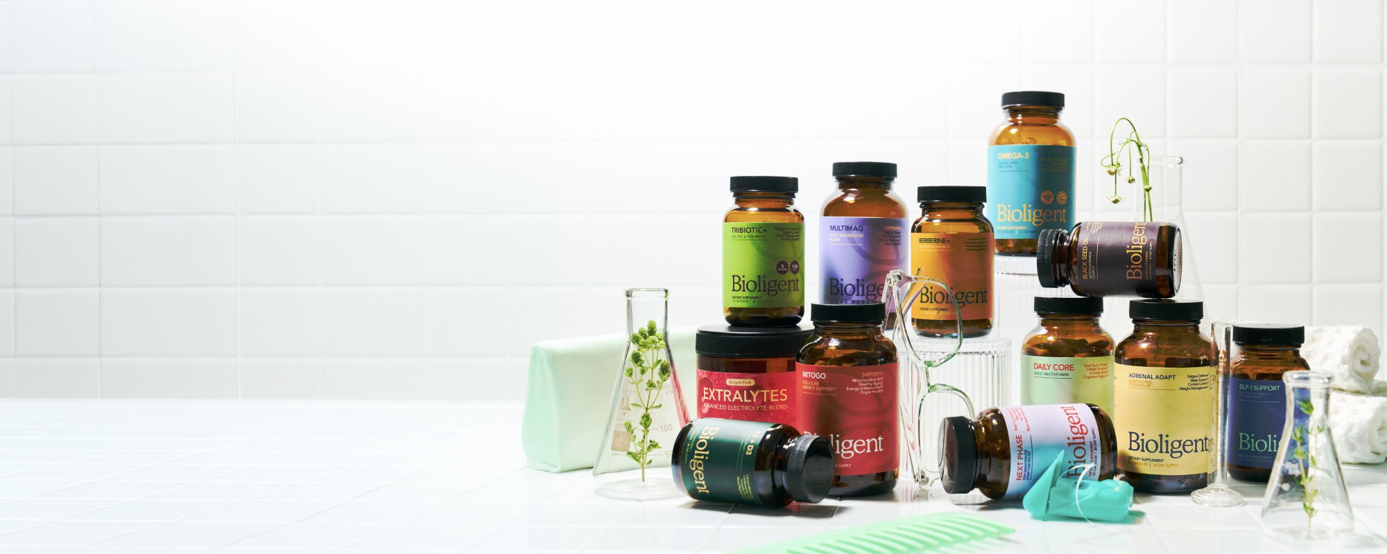 Bioligent supplement bottle lineup on a white tile studio backdrop
